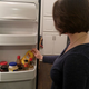 Illustration for article titled Woman Rearranging Condiments In Refrigerator Door Like Puzzle In Ancient Tomb